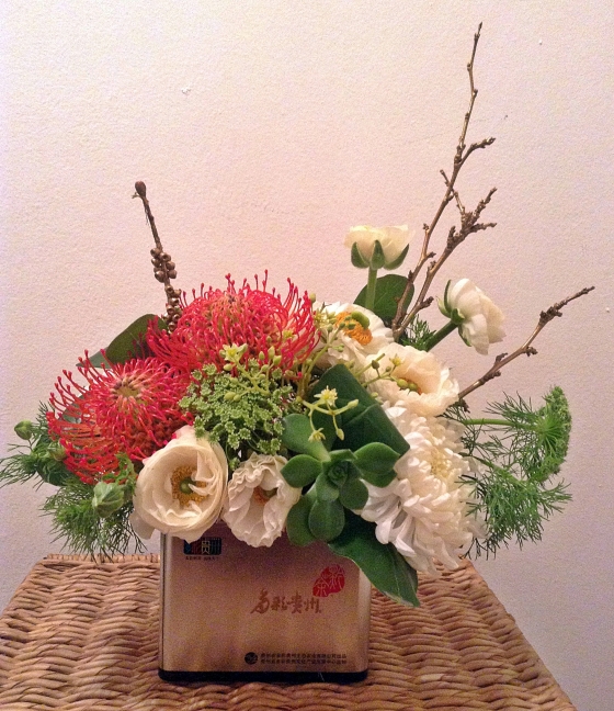 Protea, ranunculus and mum arrangements